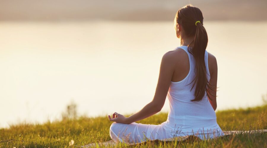 Female practicing mindfulness meditation for stress relief and focus enhancement