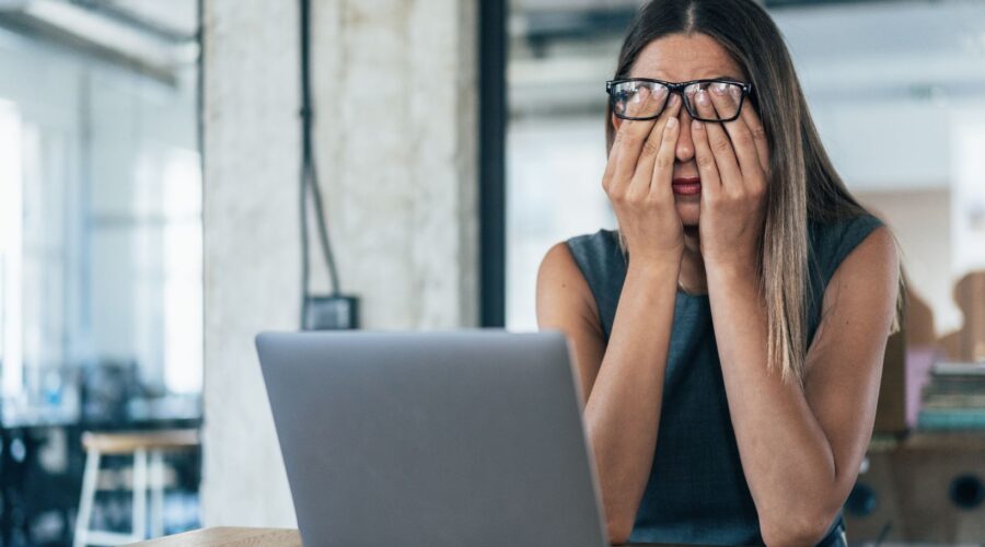A woman experiencing mental exhaustion at work, highlighting burnout, stress, and chronic fatigue beyond lack of sleep.