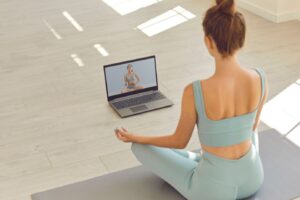 Woman participating in an online somatic therapy session from home to reduce stress and regulate the nervous system.